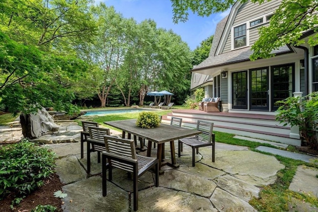 view of patio featuring an outdoor pool and outdoor dining space