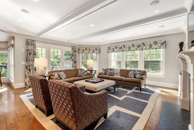 living room with baseboards, crown molding, beamed ceiling, and light wood-style floors