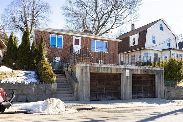 182 Kittredge St, Boston, MA 02131 - view of front of home with an attached garage, brick siding, and driveway