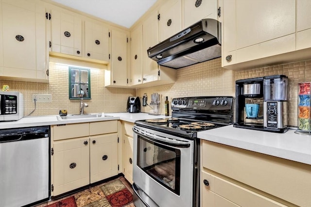 kitchen featuring tasteful backsplash, cream cabinets, stainless steel appliances, and sink