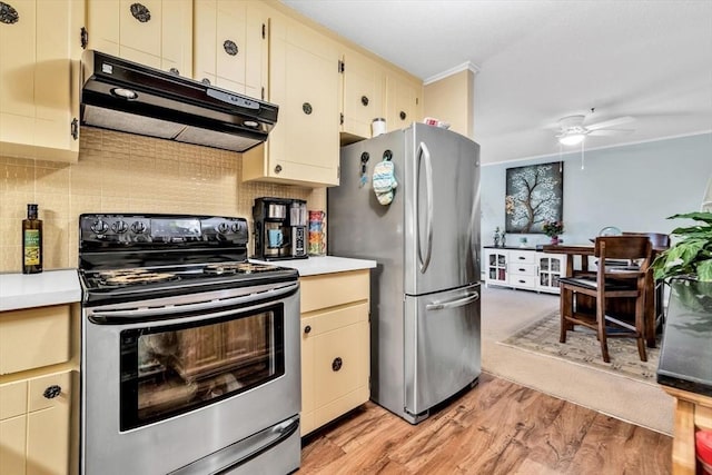 kitchen with appliances with stainless steel finishes, tasteful backsplash, light hardwood / wood-style floors, crown molding, and cream cabinetry