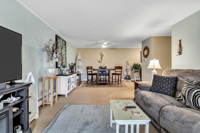 carpeted living room with ornamental molding and ceiling fan