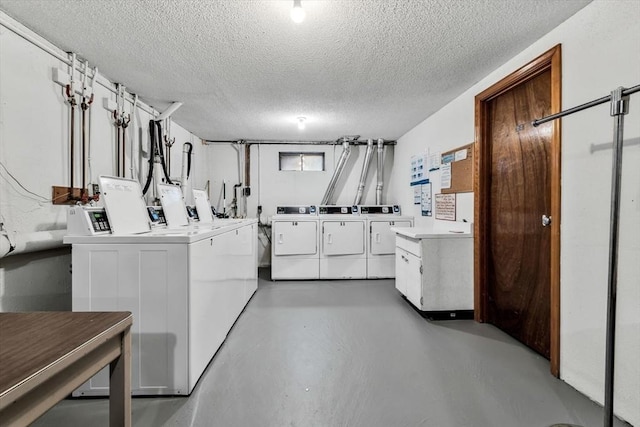 laundry area with washer and clothes dryer and a textured ceiling