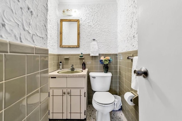 bathroom featuring tile patterned flooring, vanity, tile walls, and toilet