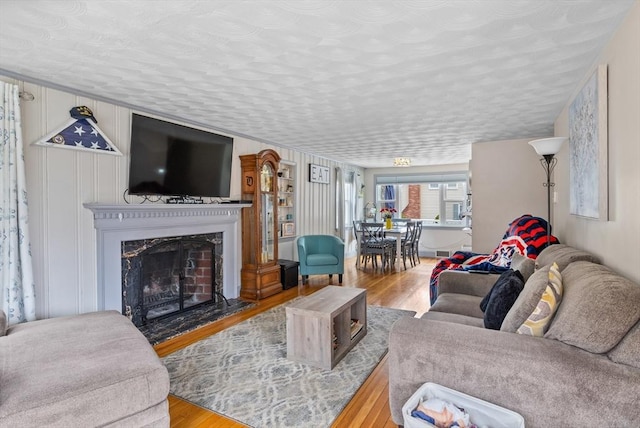 living room with wood finished floors and a fireplace