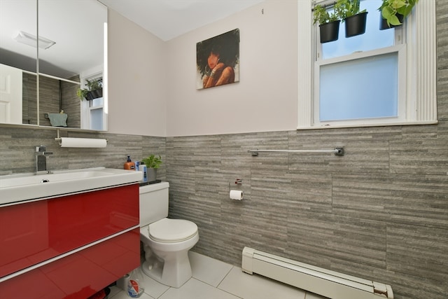 bathroom featuring tile patterned flooring, tile walls, and a baseboard heating unit