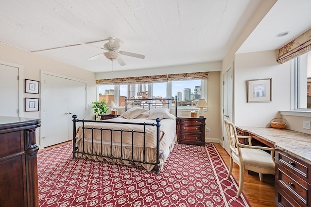 bedroom with a city view and ceiling fan