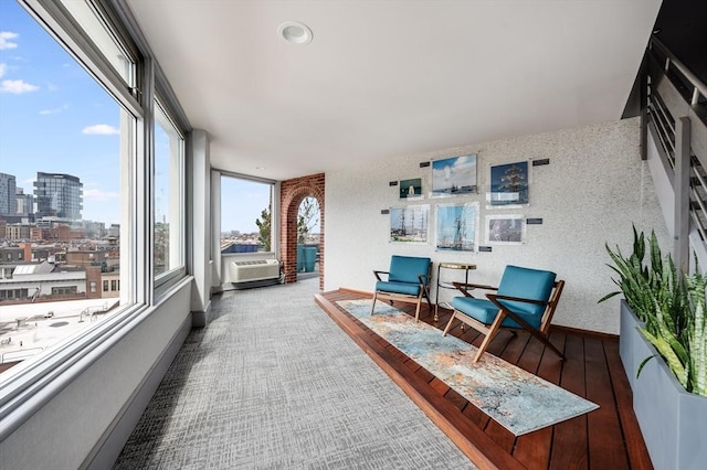 sunroom / solarium with a city view, a wealth of natural light, and cooling unit