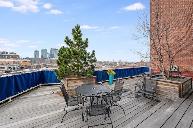 deck featuring a city view and outdoor dining space