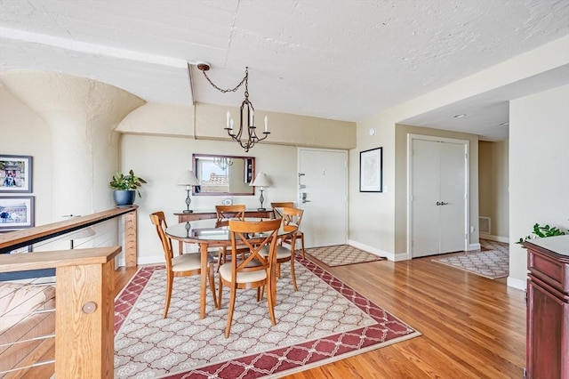 dining room featuring baseboards, wood finished floors, and visible vents