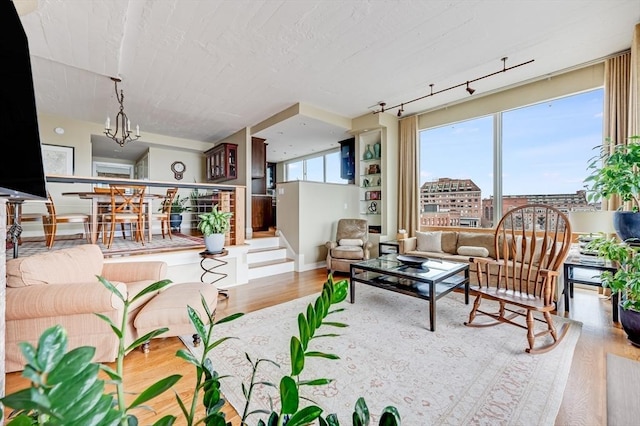 living area featuring a notable chandelier and wood finished floors