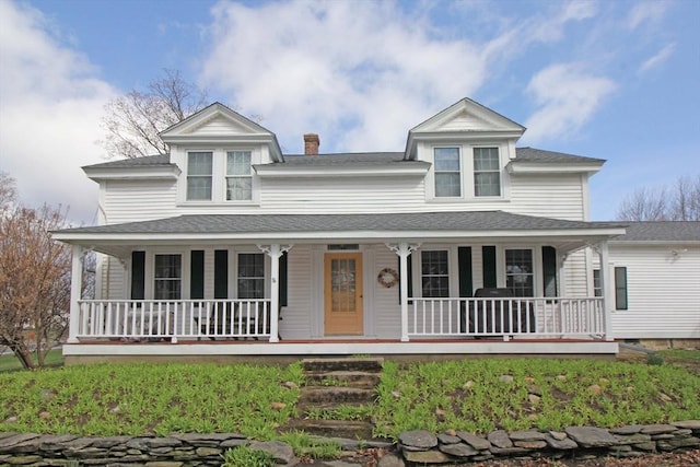 farmhouse inspired home with roof with shingles, a chimney, and a porch