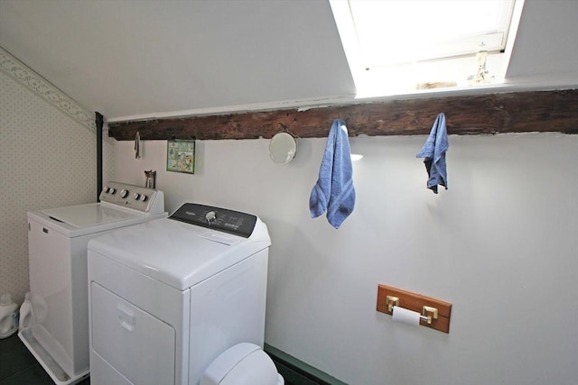 laundry area featuring washer and dryer, wallpapered walls, and laundry area