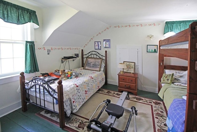 bedroom with vaulted ceiling and baseboards