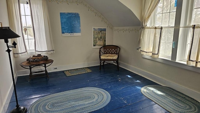 living area with a healthy amount of sunlight, baseboards, and wood-type flooring