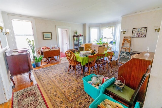dining area featuring crown molding and wood finished floors
