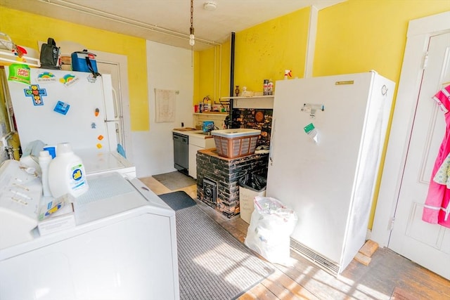 interior space featuring laundry area, light wood-type flooring, and washing machine and clothes dryer