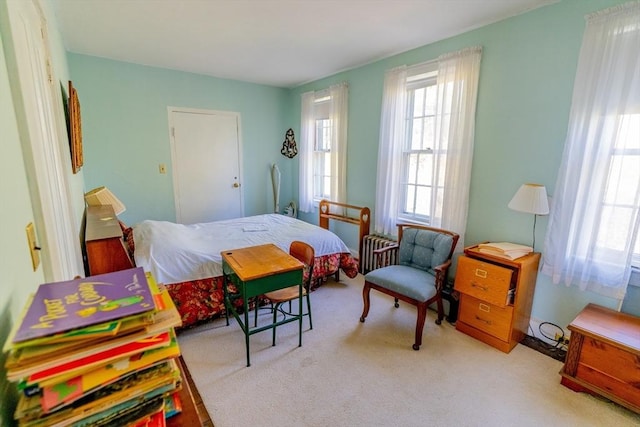 carpeted bedroom with radiator heating unit