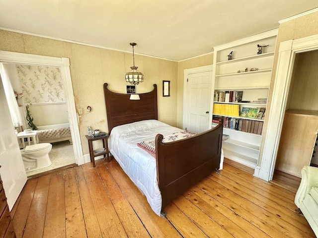 bedroom featuring crown molding and hardwood / wood-style flooring