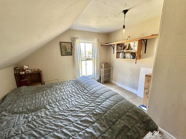carpeted bedroom featuring baseboards and vaulted ceiling