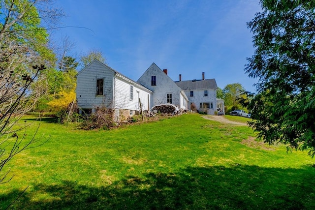 back of property featuring a yard