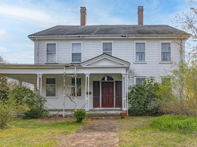 view of front of property with a shingled roof, a chimney, and a porch