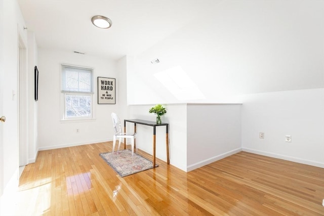 bonus room featuring visible vents, lofted ceiling, light wood-style floors, and baseboards