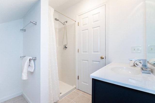 bathroom with tile patterned floors, a shower stall, vanity, and baseboards