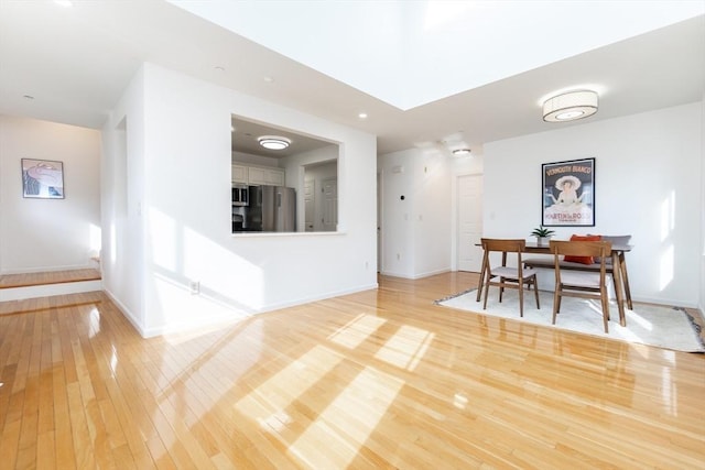 dining room with baseboards and light wood-style floors