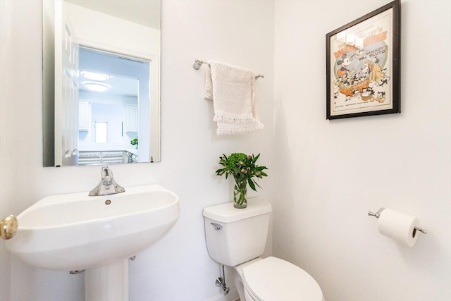 bathroom with toilet and a sink