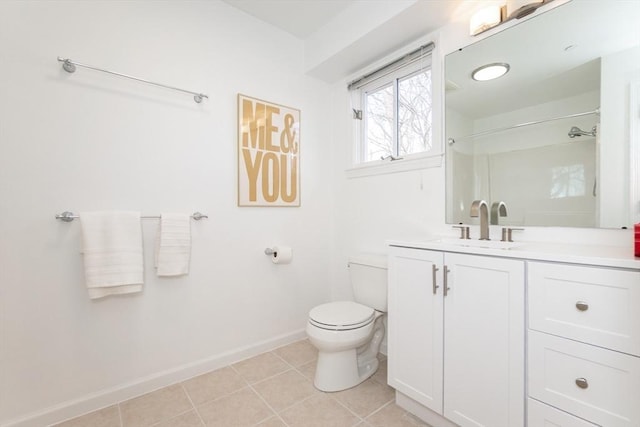 bathroom with tile patterned floors, toilet, vanity, and baseboards