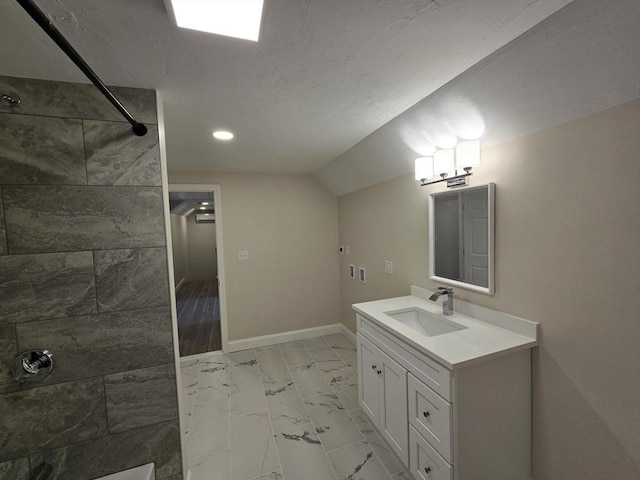 bathroom featuring recessed lighting, baseboards, marble finish floor, a tile shower, and vanity