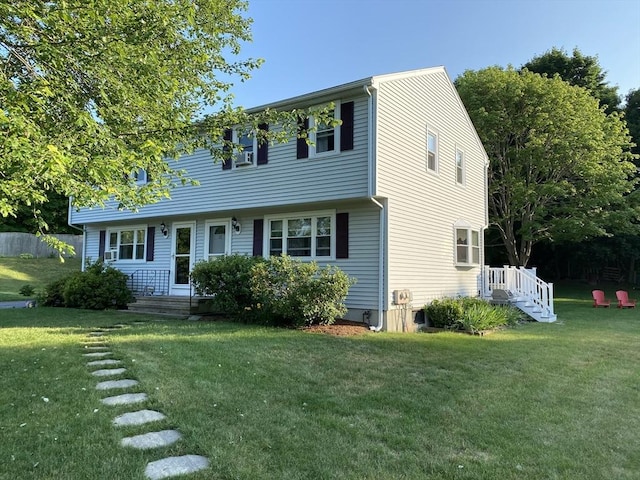 colonial-style house with a front yard