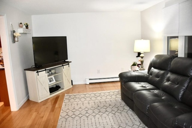 living room with hardwood / wood-style flooring and a baseboard heating unit