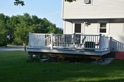 wooden terrace featuring a yard