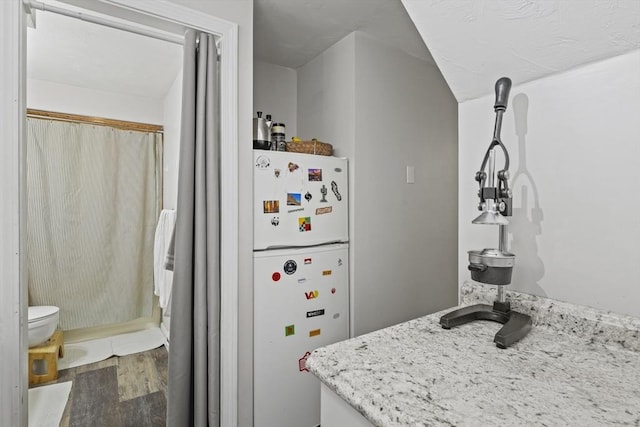516 High St Unit 516, Clinton, MA 01510 - kitchen featuring freestanding refrigerator, wood finished floors, and light stone countertops
