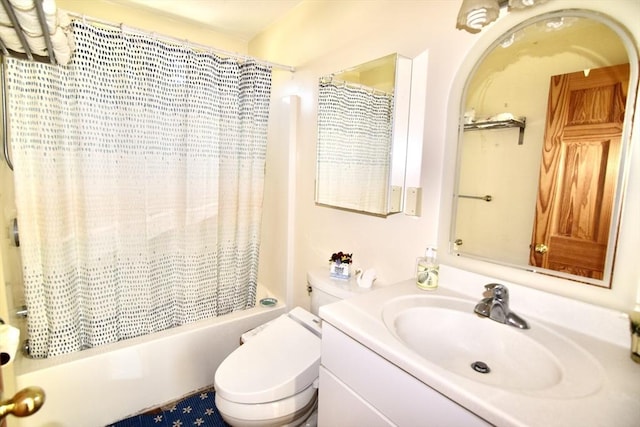 bathroom with vanity, shower / bath combo, and toilet
