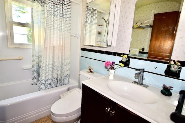 bathroom with vanity, toilet, shower / bathtub combination with curtain, and tile walls