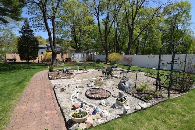view of yard featuring a fenced backyard and an outdoor structure