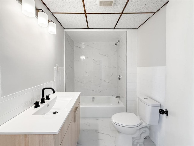 full bath featuring visible vents, shower / bathtub combination, toilet, and tile walls