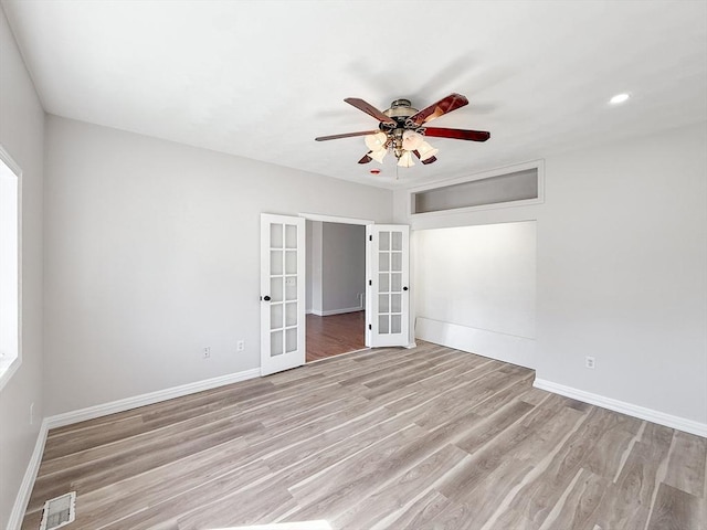 unfurnished bedroom with ceiling fan, french doors, baseboards, light wood-type flooring, and visible vents
