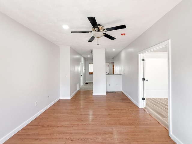 unfurnished living room with baseboards, recessed lighting, ceiling fan, and light wood-type flooring