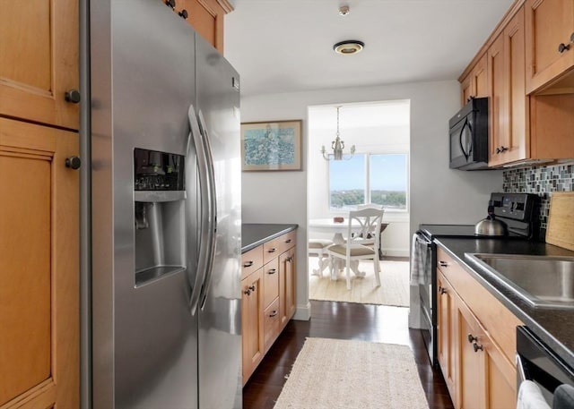 73 Broad Reach Unit T111C, Weymouth, MA 02191 - kitchen with appliances with stainless steel finishes, dark countertops, dark wood finished floors, and a chandelier