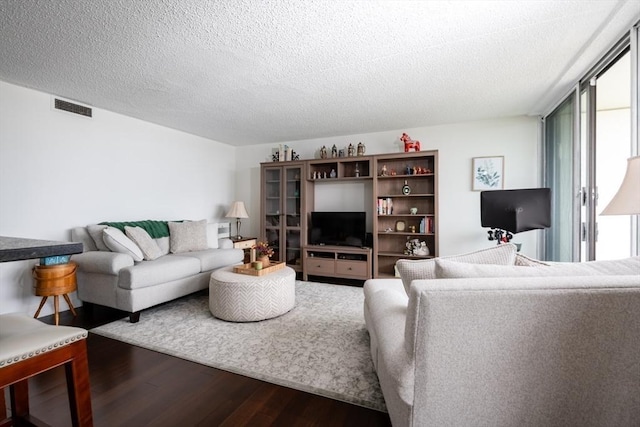 73 Broad Reach Unit T111C, Weymouth, MA 02191 - living area featuring wood finished floors, healthy amount of natural light, and a textured ceiling