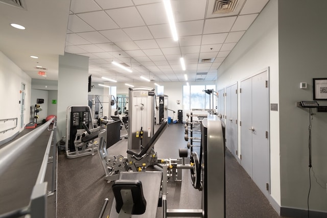 gym with a paneled ceiling