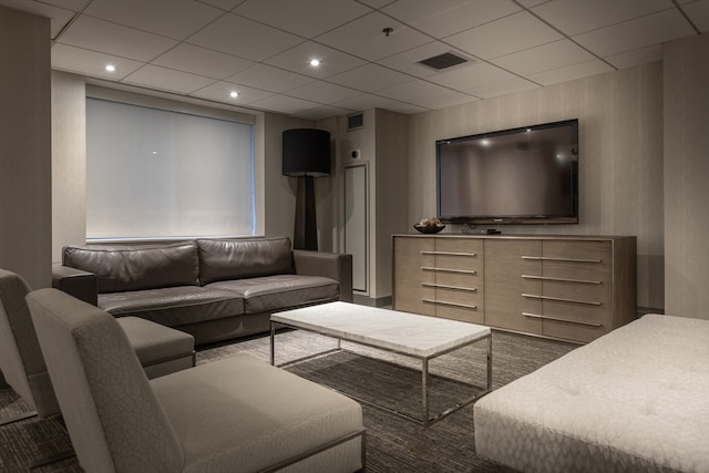 living room featuring a drop ceiling