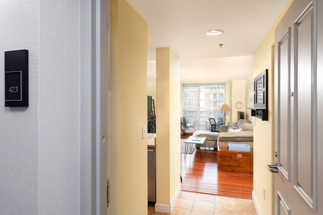 hallway with light hardwood / wood-style flooring