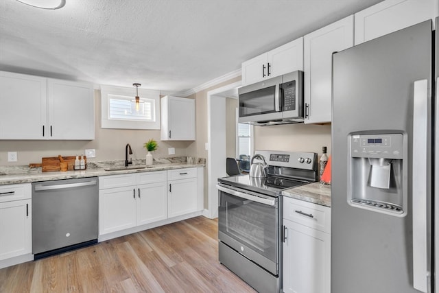 kitchen featuring white cabinetry, light hardwood / wood-style floors, appliances with stainless steel finishes, and sink