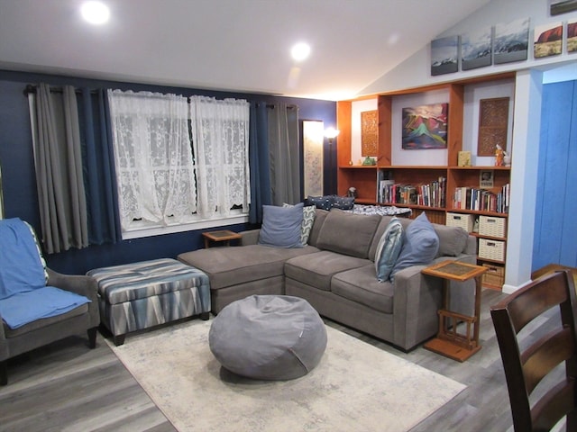 living room with hardwood / wood-style floors and vaulted ceiling