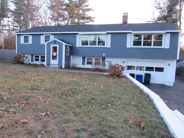 split foyer home with a front yard and a garage